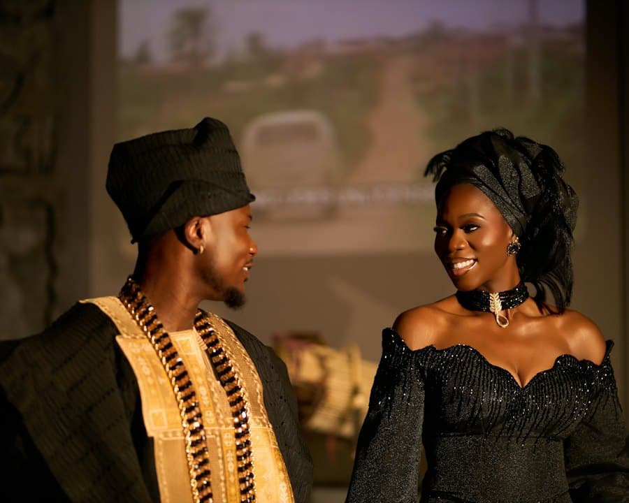 A couple in native wear smiling at each other