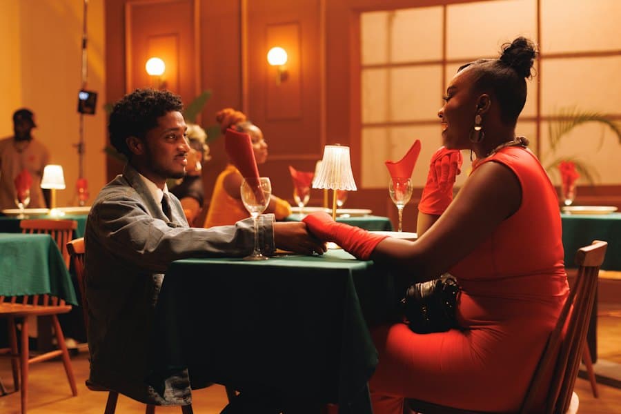 A couple holding hands across a lamplit restaurant table